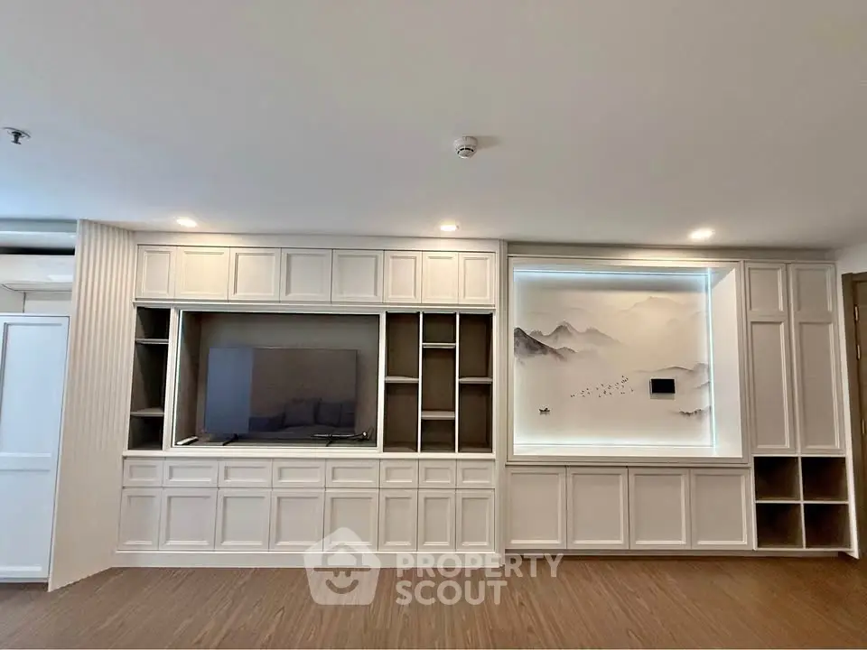 Elegant living room with built-in TV unit and artistic wall paneling