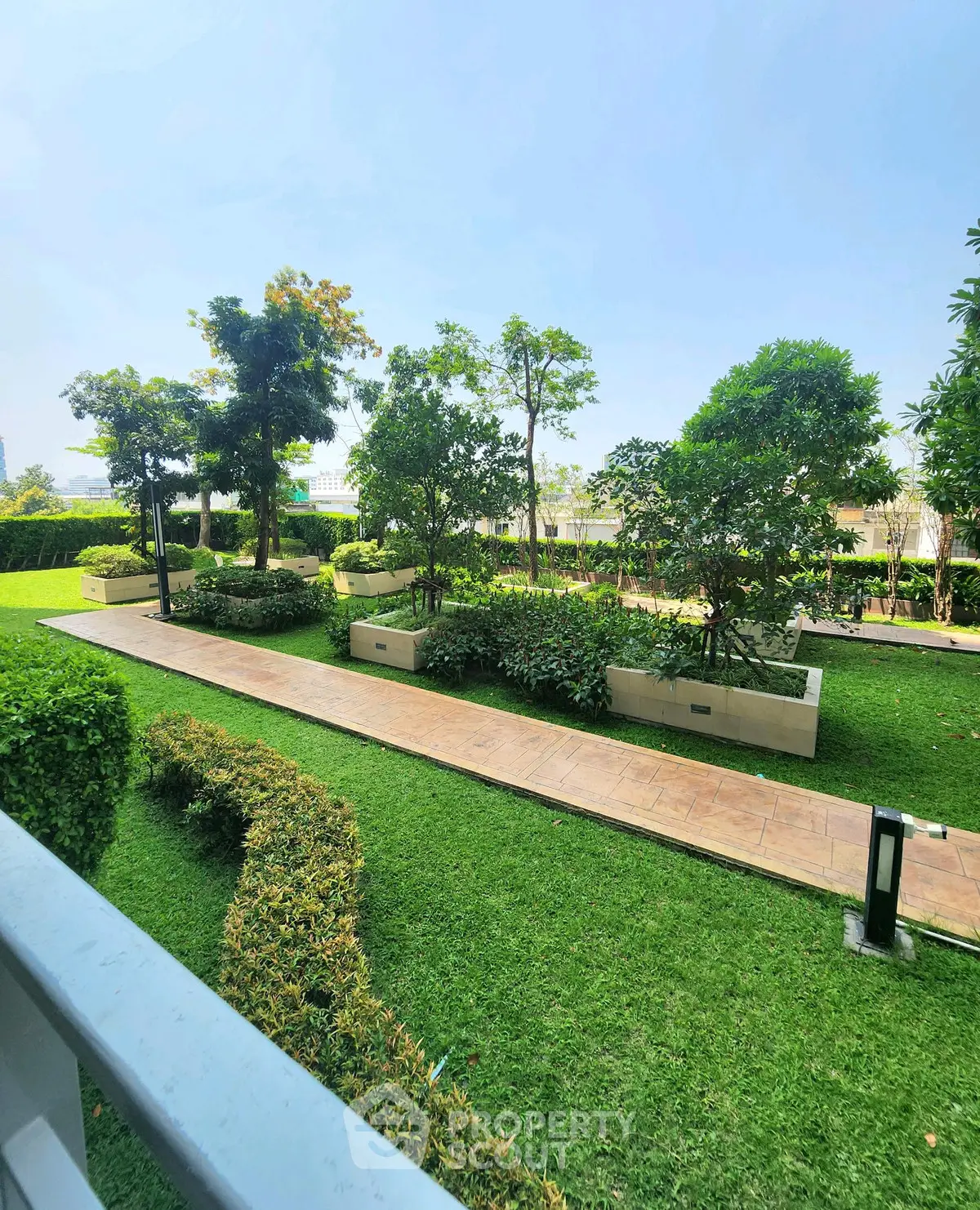 Lush green garden with pathway in modern residential complex