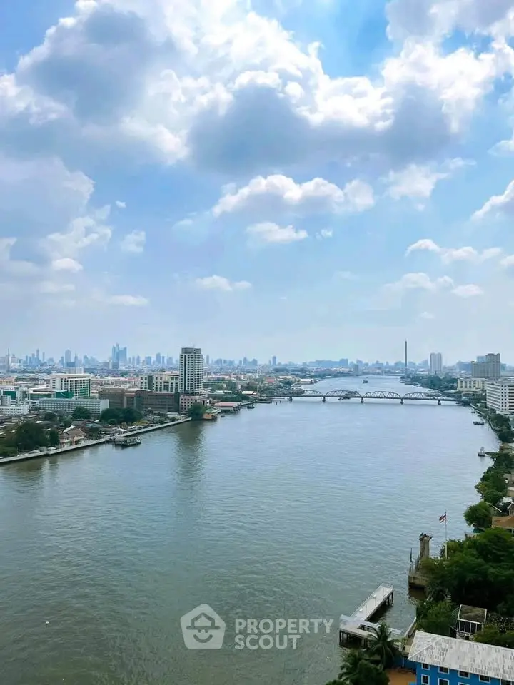 Stunning river view from high-rise building showcasing city skyline and serene waterway.