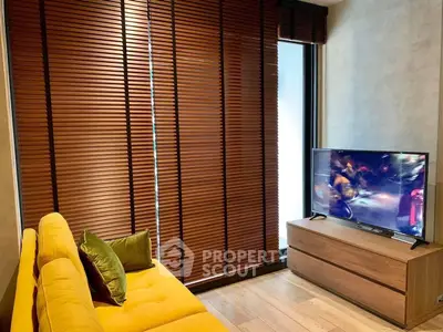 Cozy living room with yellow sofa and TV, featuring wooden blinds and modern decor.