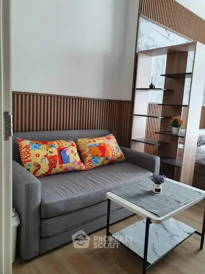 Charming living room with cozy sofa and stylish decor, perfect for relaxation and modern living.