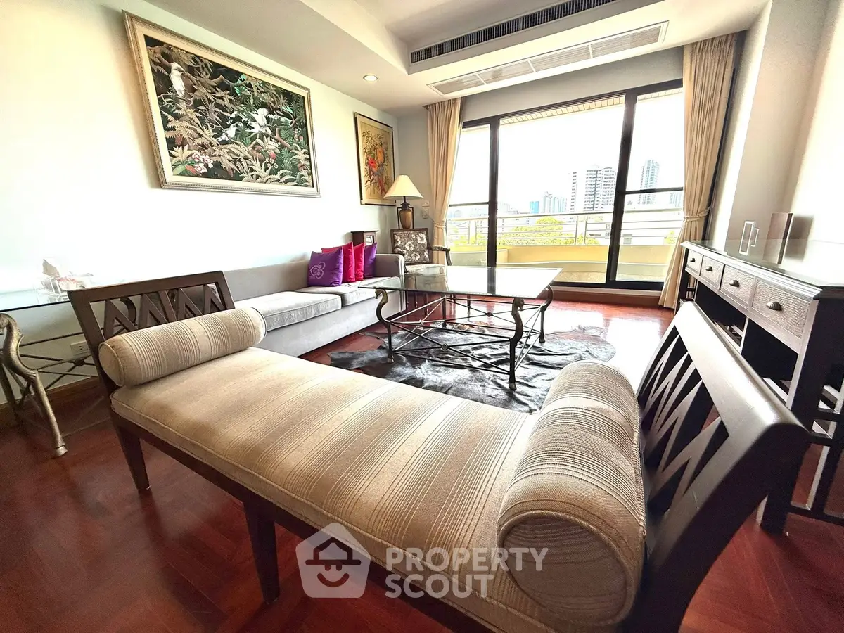 Luxurious living room with elegant furniture and city view balcony in high-rise apartment.