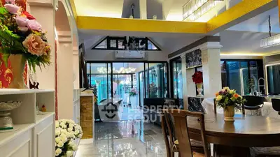 Luxurious open-plan living room with elegant decor and large windows