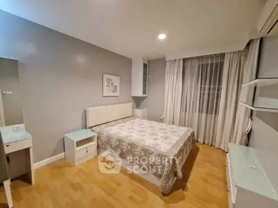 Spacious bedroom with modern decor and natural light, featuring a comfortable bed and stylish furnishings.