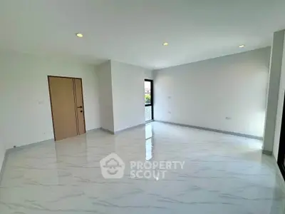 Spacious empty room with glossy marble flooring and large windows for natural light.