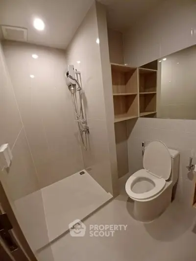 Modern bathroom with sleek shower and toilet in minimalist design