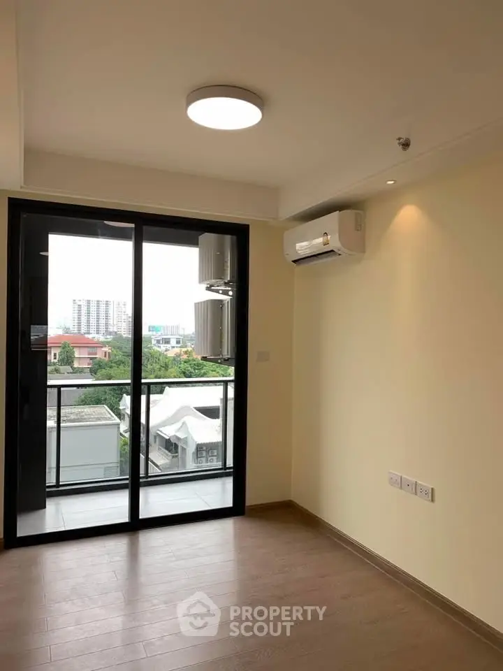 Modern apartment with balcony and air conditioning, offering a bright and airy living space with city views.