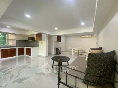 Spacious open-plan living room with modern kitchen and elegant decor