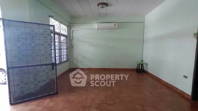 Spacious empty room with tiled floor and air conditioning unit