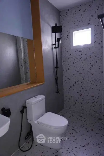 Modern bathroom with terrazzo tiles and sleek fixtures