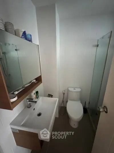 Modern bathroom with sleek fixtures and glass shower enclosure