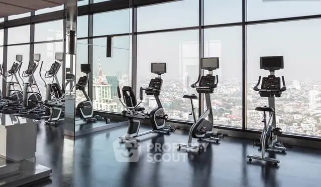 Luxurious high-rise gym with panoramic city views and modern fitness equipment.