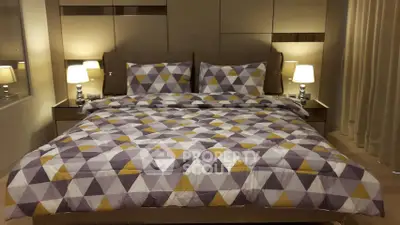 Luxurious bedroom with modern geometric bedding and ambient lighting