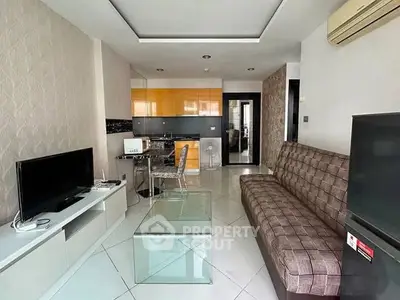 Modern living room with sleek furniture and open kitchen layout in stylish apartment.