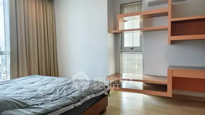 Modern bedroom with stylish shelving and city view, perfect for urban living.
