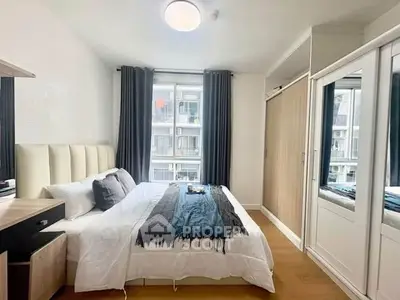 Modern bedroom with stylish decor and ample natural light from large window.