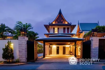 Stunning luxury villa with unique architectural design and spacious entrance at dusk.