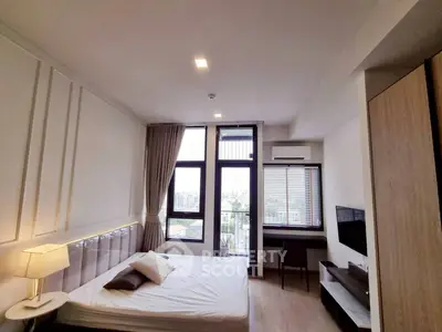 Modern bedroom with city view, featuring sleek design and natural light.