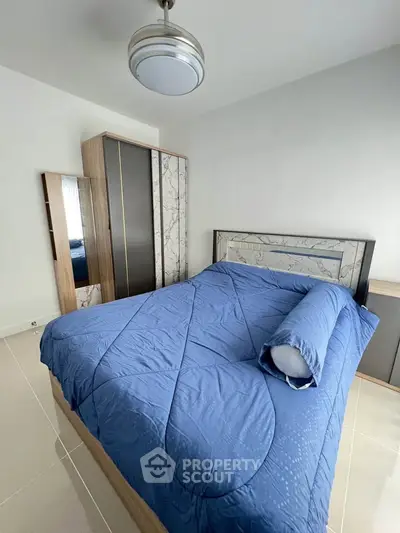 Modern bedroom with stylish wardrobe and blue bedding