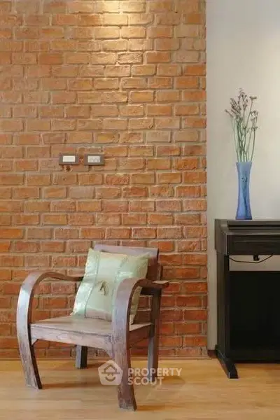 Stylish interior with exposed brick wall and elegant wooden chair