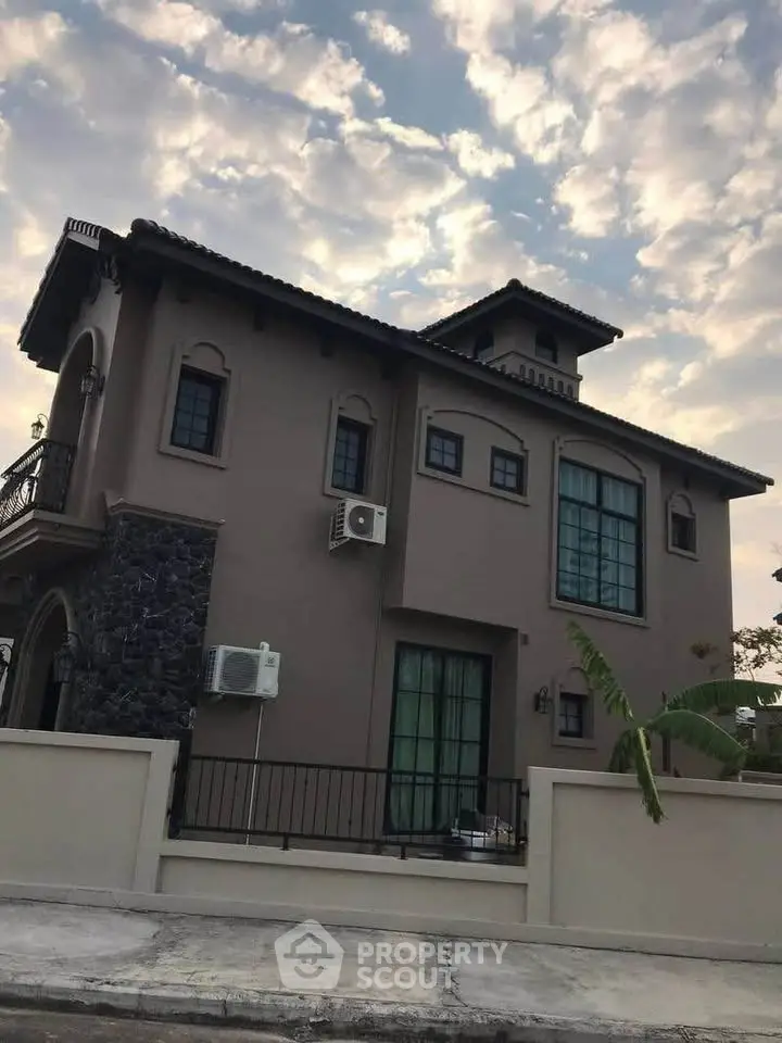 Elegant two-story house with modern architecture and stylish exterior design under a picturesque sky.