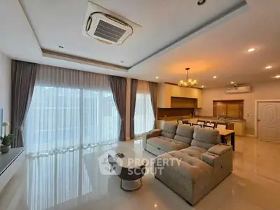 Spacious modern living room with open kitchen and elegant furnishings