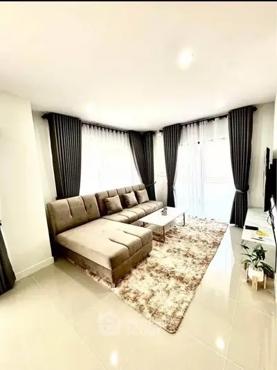 Spacious modern living room with elegant L-shaped sofa and large windows