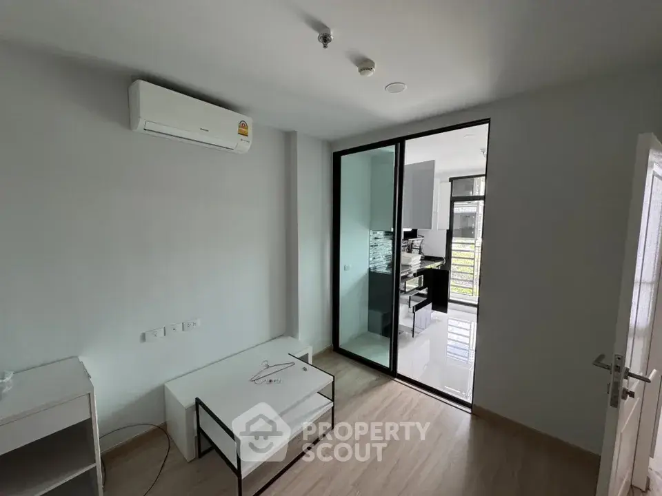Modern apartment interior with air conditioning and glass partitioned kitchen