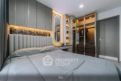 Luxurious bedroom with modern design, featuring an elegant bed with plush headboard, stylish lighting, and mirrored wardrobe doors enhancing the spacious feel.