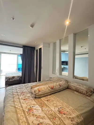 Luxurious bedroom with elegant decor and large windows offering natural light.