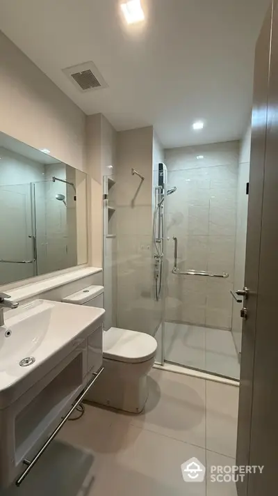 Modern bathroom with sleek fixtures and glass shower enclosure