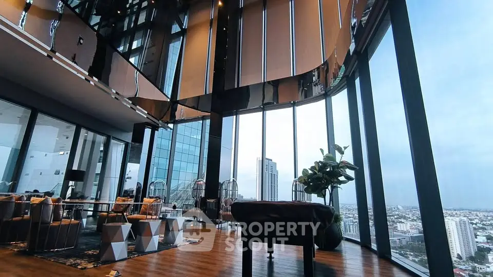 Luxurious high-rise living room with panoramic city views and modern decor.