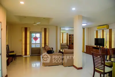 Spacious living room with modern furniture and natural light, perfect for family gatherings.