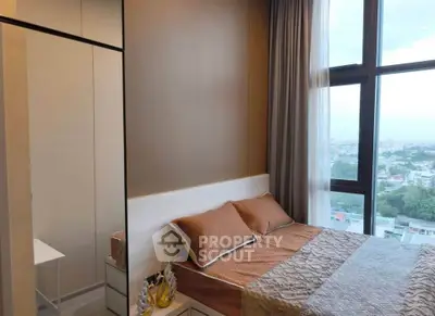 Modern bedroom with large window offering stunning city view, elegant decor, and cozy ambiance.