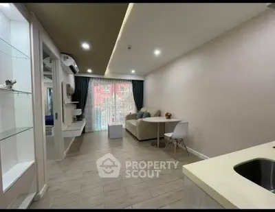 Modern living room with open layout and stylish decor, featuring a cozy sofa and elegant dining area.