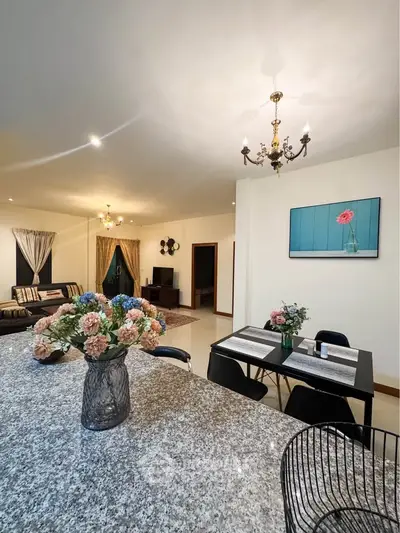 Elegant living room with stylish decor and spacious dining area, perfect for modern living.