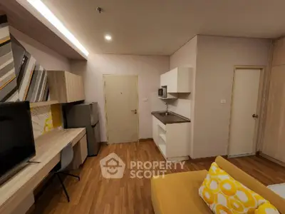 Modern studio apartment with stylish decor and compact kitchen