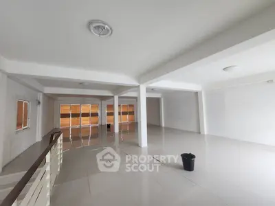 Spacious open-plan interior with modern design and ample natural light, ideal for versatile use.