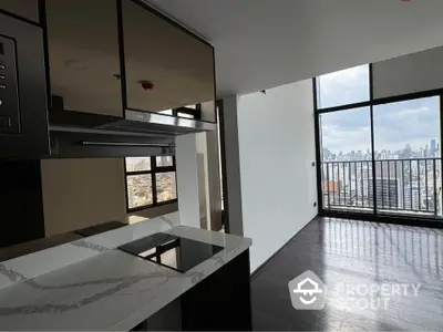 Modern apartment with sleek kitchen and stunning city view from balcony.