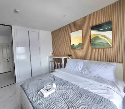 Modern bedroom with stylish decor and cozy bedding in a contemporary apartment.