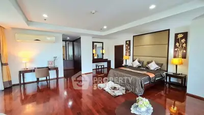 Luxurious bedroom with elegant decor and hardwood floors in a spacious apartment.
