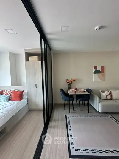 Modern studio apartment with stylish decor, featuring a cozy dining area and comfortable living space.