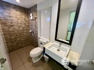 Modern bathroom with sleek design and wall-mounted shower in contemporary apartment.