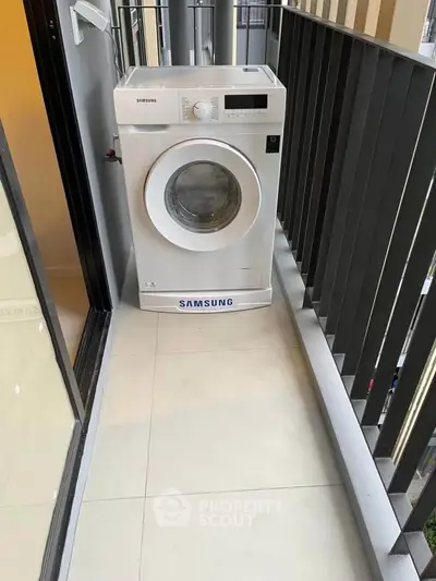 Compact balcony with washing machine, ideal for urban living spaces.
