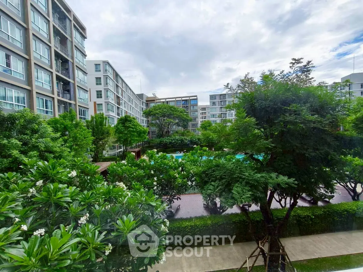 Modern residential complex with lush gardens and pool view
