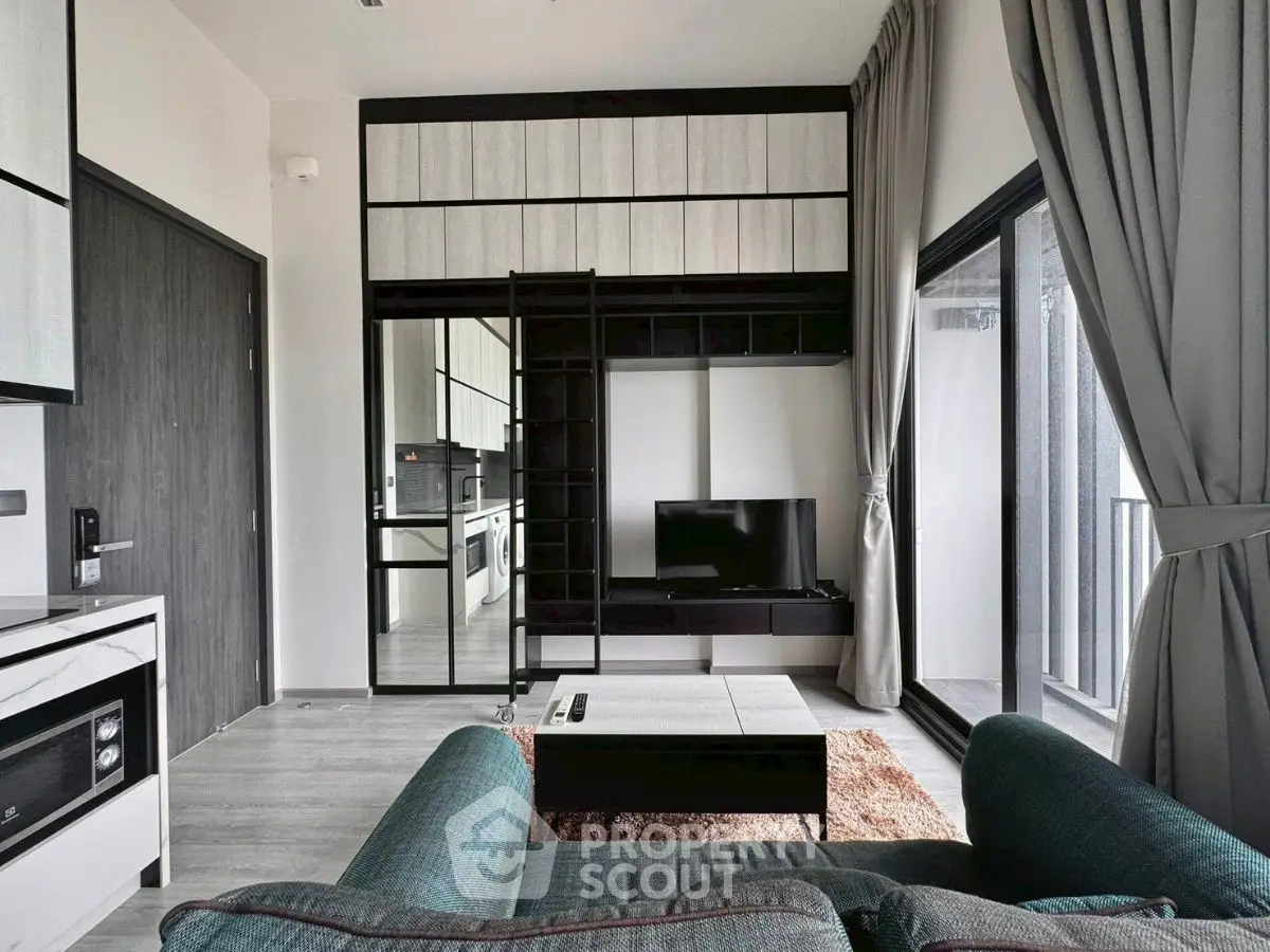 Modern living room with sleek furniture and large windows for natural light.