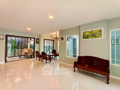 Spacious living room with elegant furniture and large windows offering natural light.