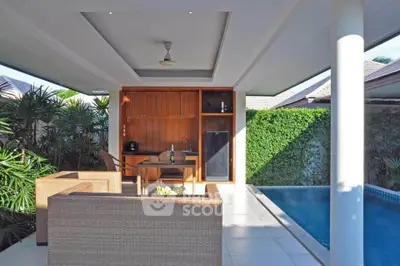 Luxurious poolside patio with modern outdoor kitchen and seating area.