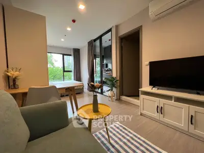 Modern living room with stylish decor and natural light in a cozy apartment.