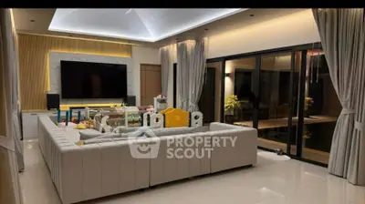 Luxurious living room with modern decor and large sectional sofa, perfect for family gatherings.